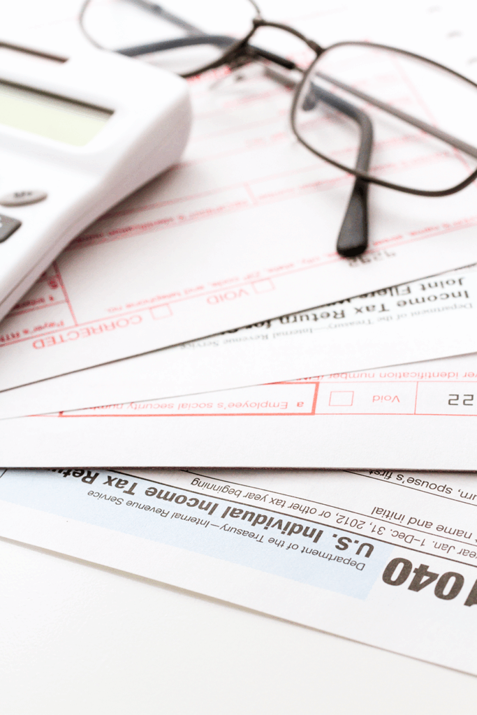 A stack of tax forms being prepared by Cheshier Tax Resolution.
